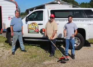 Three people in front of RJ's Power Equipment truck